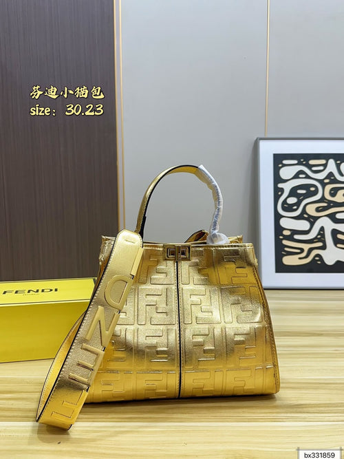 A Gold Metallic Fendi Handbag with embossed FF Logo Pattern. The bag features a Top handle, a matching Shoulder strap 